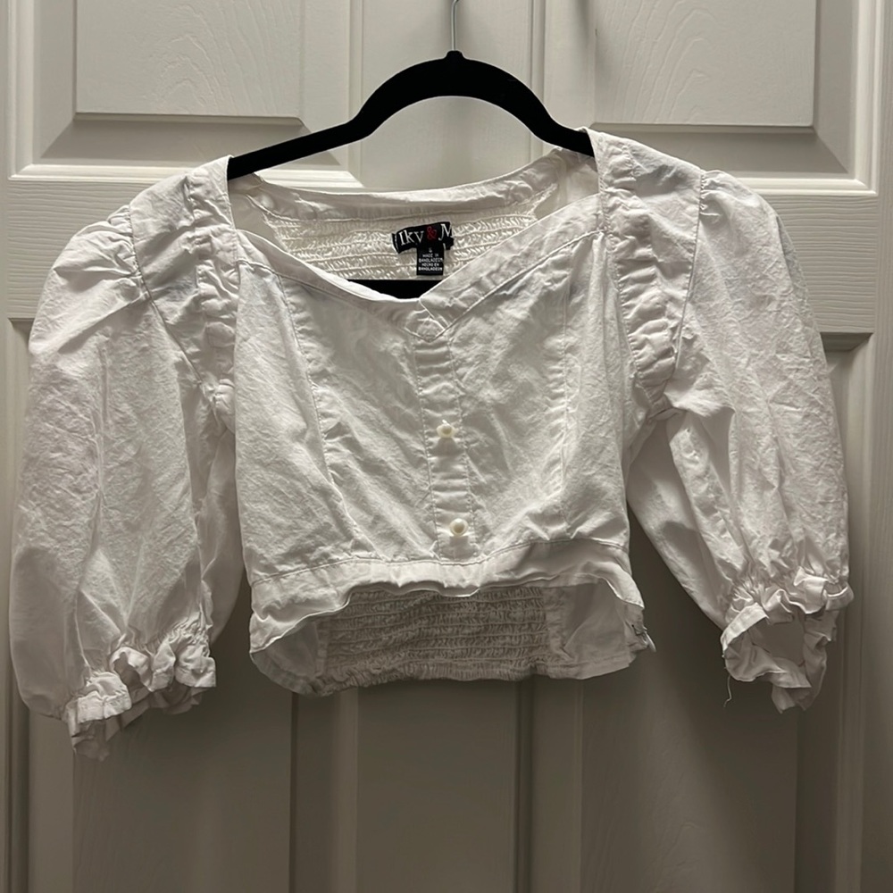 white blouse with 2 pearl buttons with a stretchy back